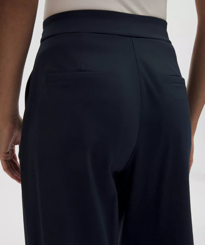 Black pants on a person against a white background