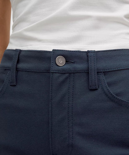 Close-up of navy pants with a button on a white background