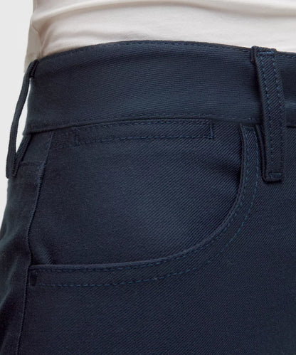 Close-up of navy blue pants with a white background