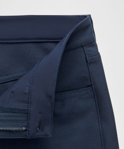 Close-up of a navy blue jacket with a zipper on a light gray background