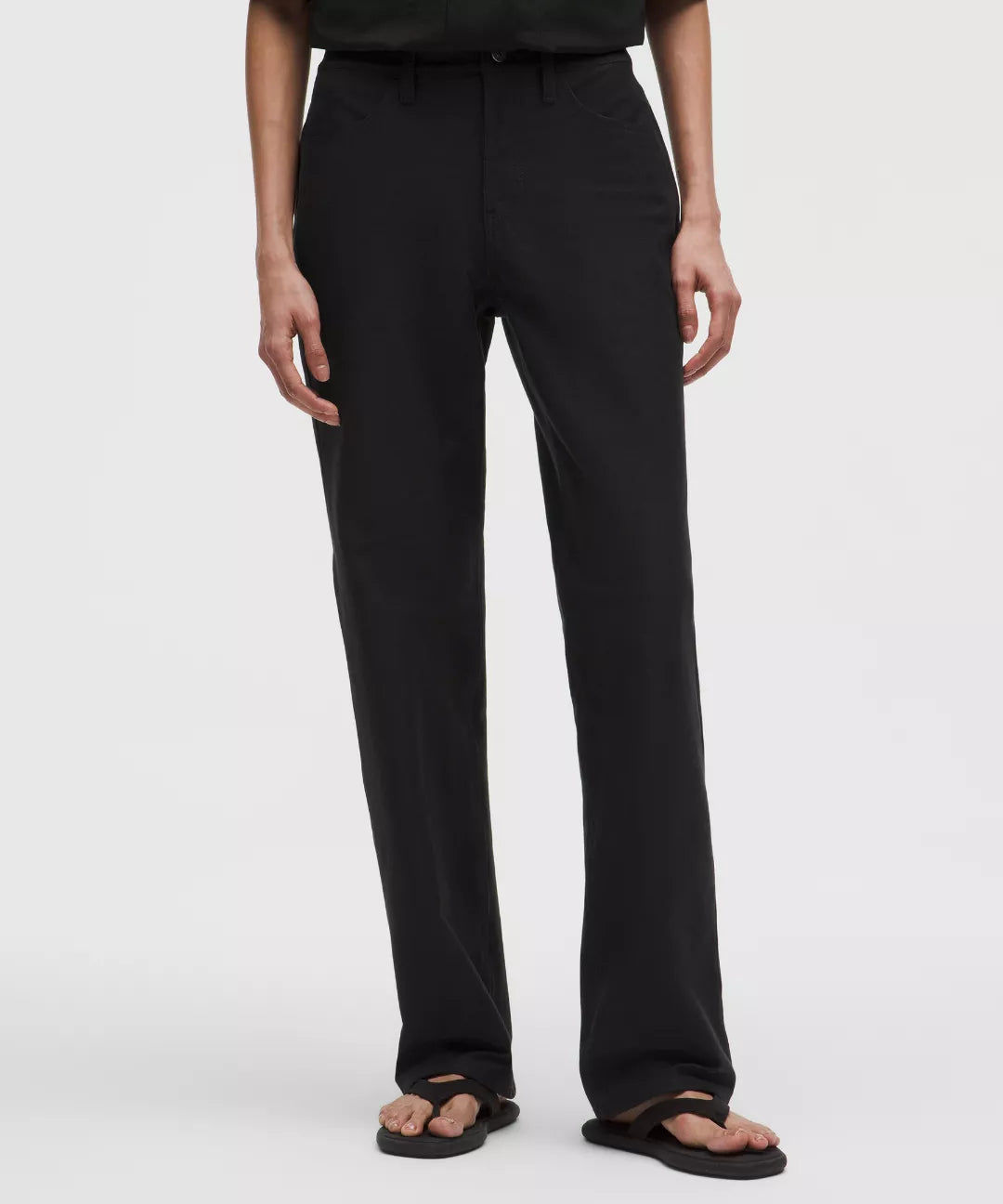 Person wearing black pants on a white background