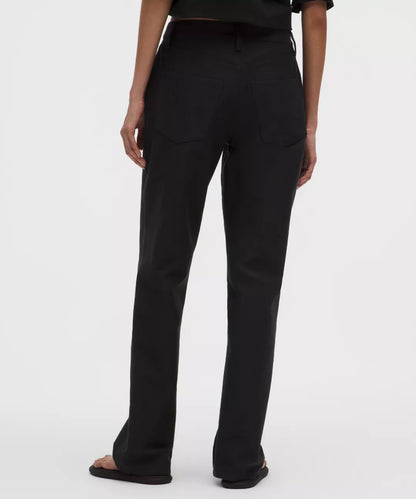 Black pants worn by a person on a white background