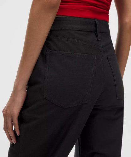 Black pants worn by a person on a white background