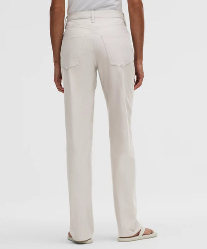 Beige pants worn by a person on a white background