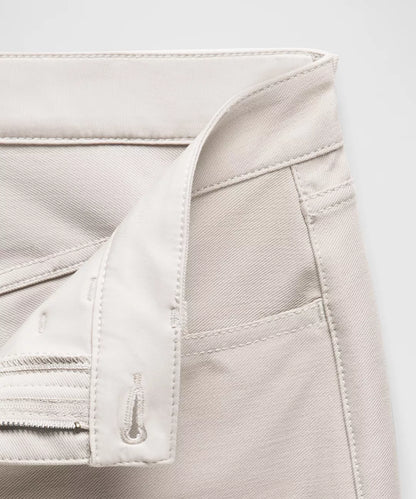 Close-up of a beige jacket with a zipper on a light gray background