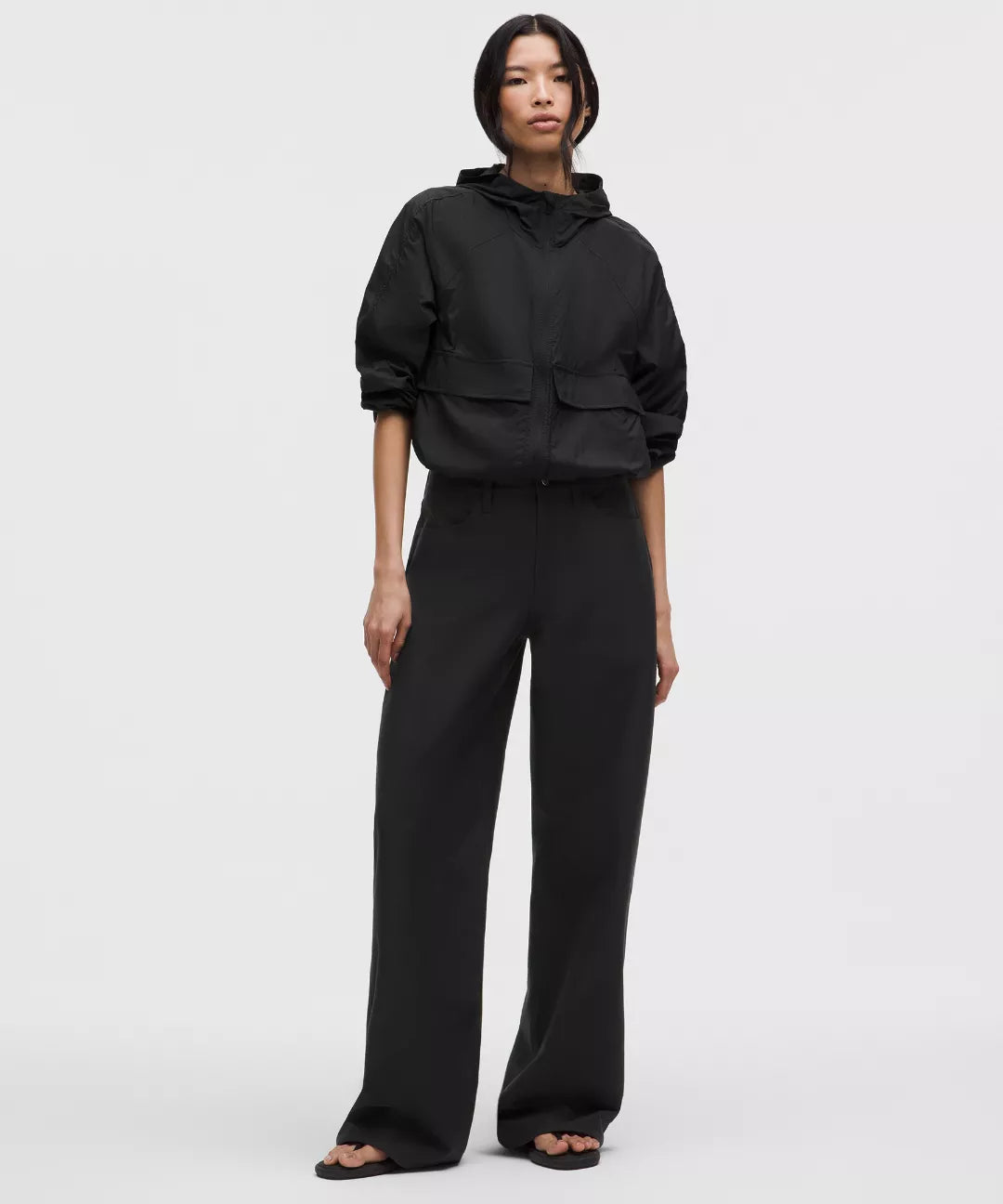 Person wearing a black outfit on a white background