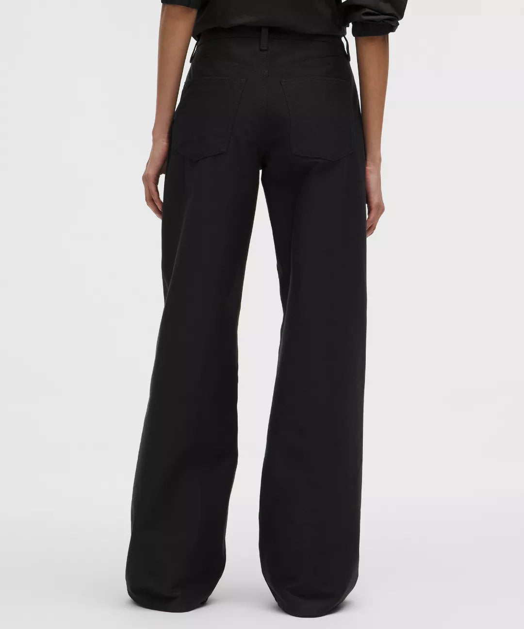 Black wide-leg pants worn by a person on a white background