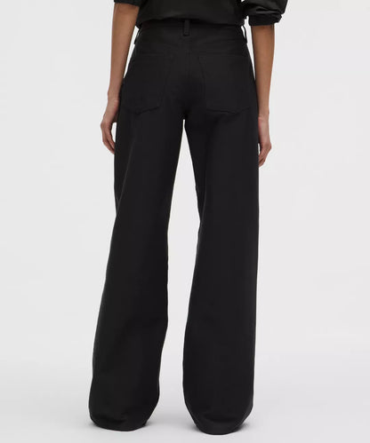 Black wide-leg pants worn by a person on a white background