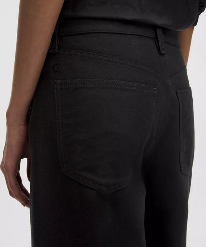Close-up of black pants with a white background