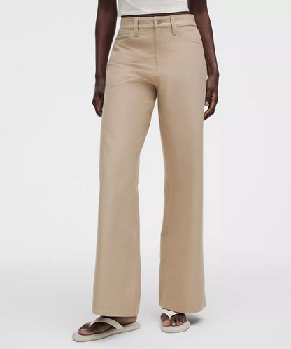 Beige wide-leg pants worn by a person on a white background