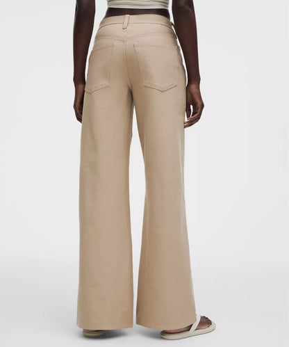 Beige wide-leg pants worn by a person on a white background