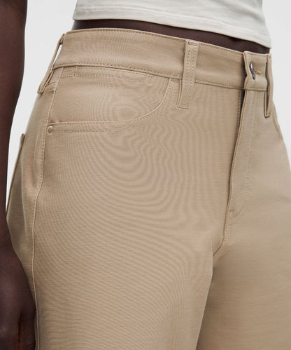 Close-up of beige pants with a white background
