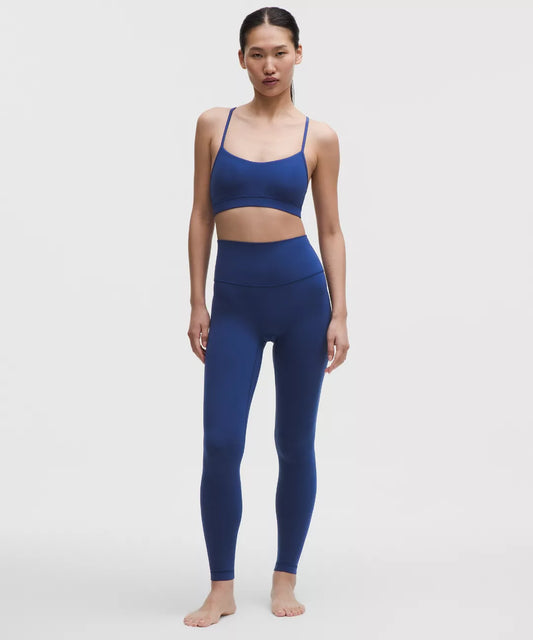Woman wearing a blue athletic outfit on a white background