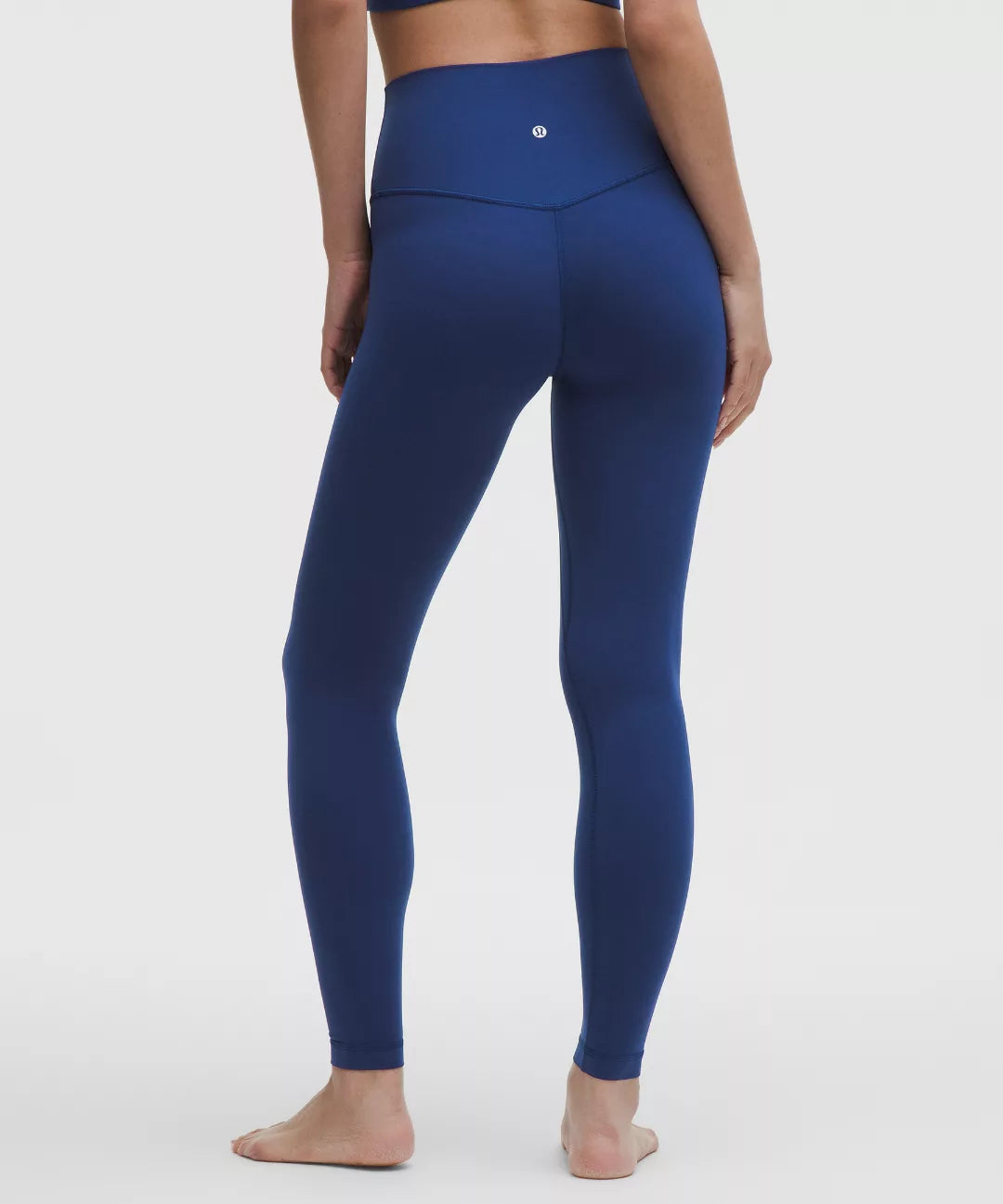 Blue leggings worn by a person on a white background