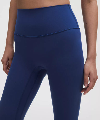 Blue leggings worn by a person on a white background