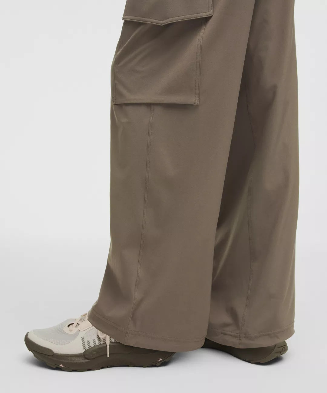 Brown pants worn by a person on a white background