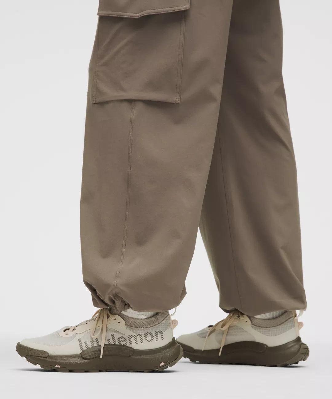 Brown cargo pants and white sneakers with 'littlemon' branding on a light gray background