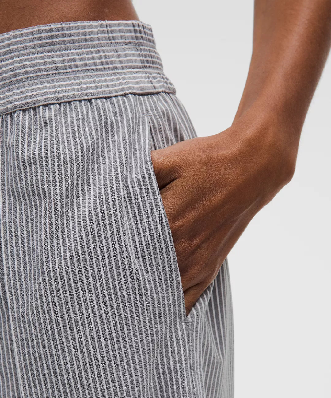 Gray striped pants with a white background