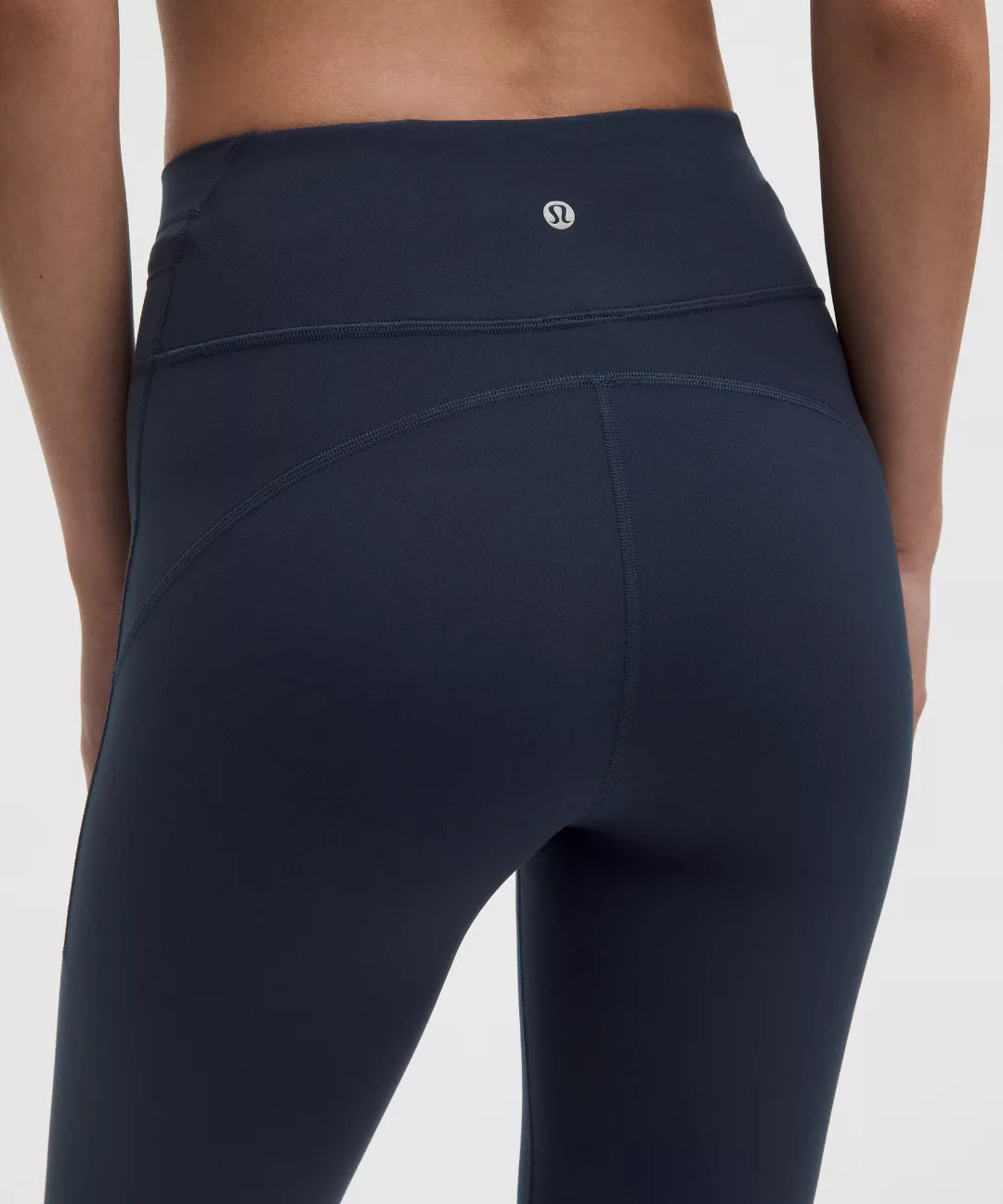 Navy blue leggings with a brand logo on a white background