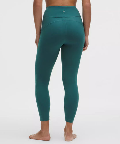Teal leggings worn by a person on a white background