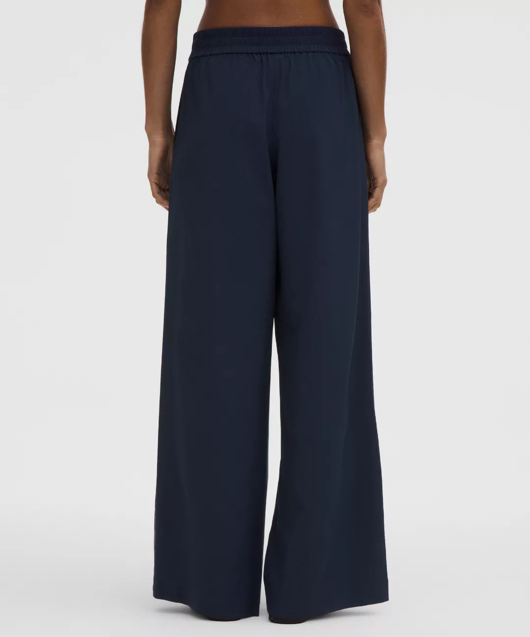 Navy wide-leg pants worn by a person on a white background