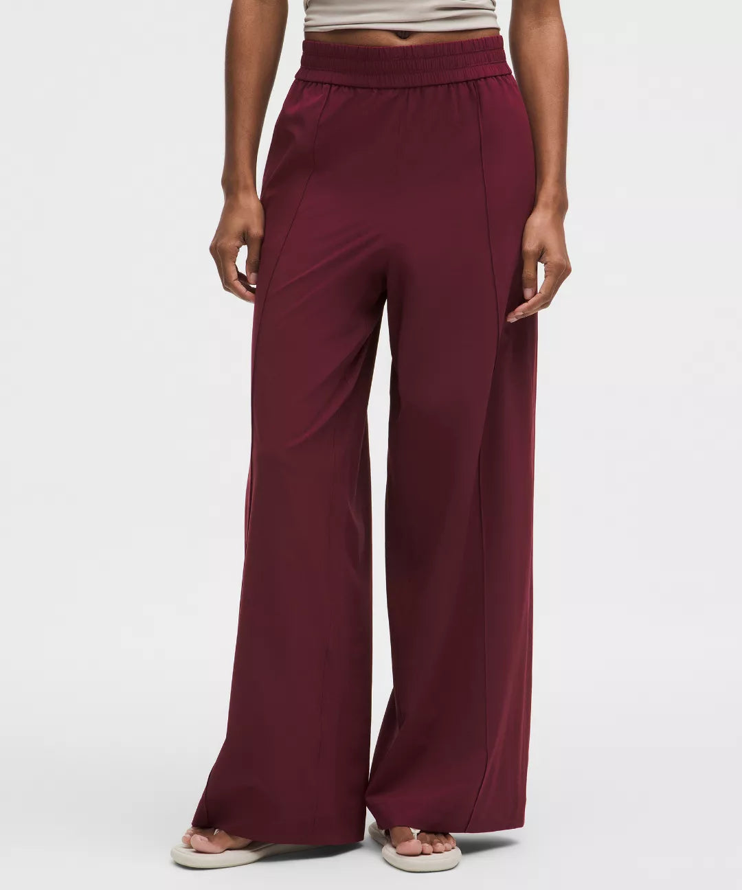 Maroon wide-leg pants worn by a person on a white background