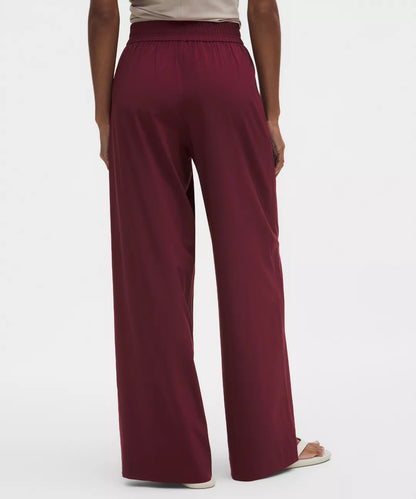 Maroon wide-leg pants worn by a person on a white background