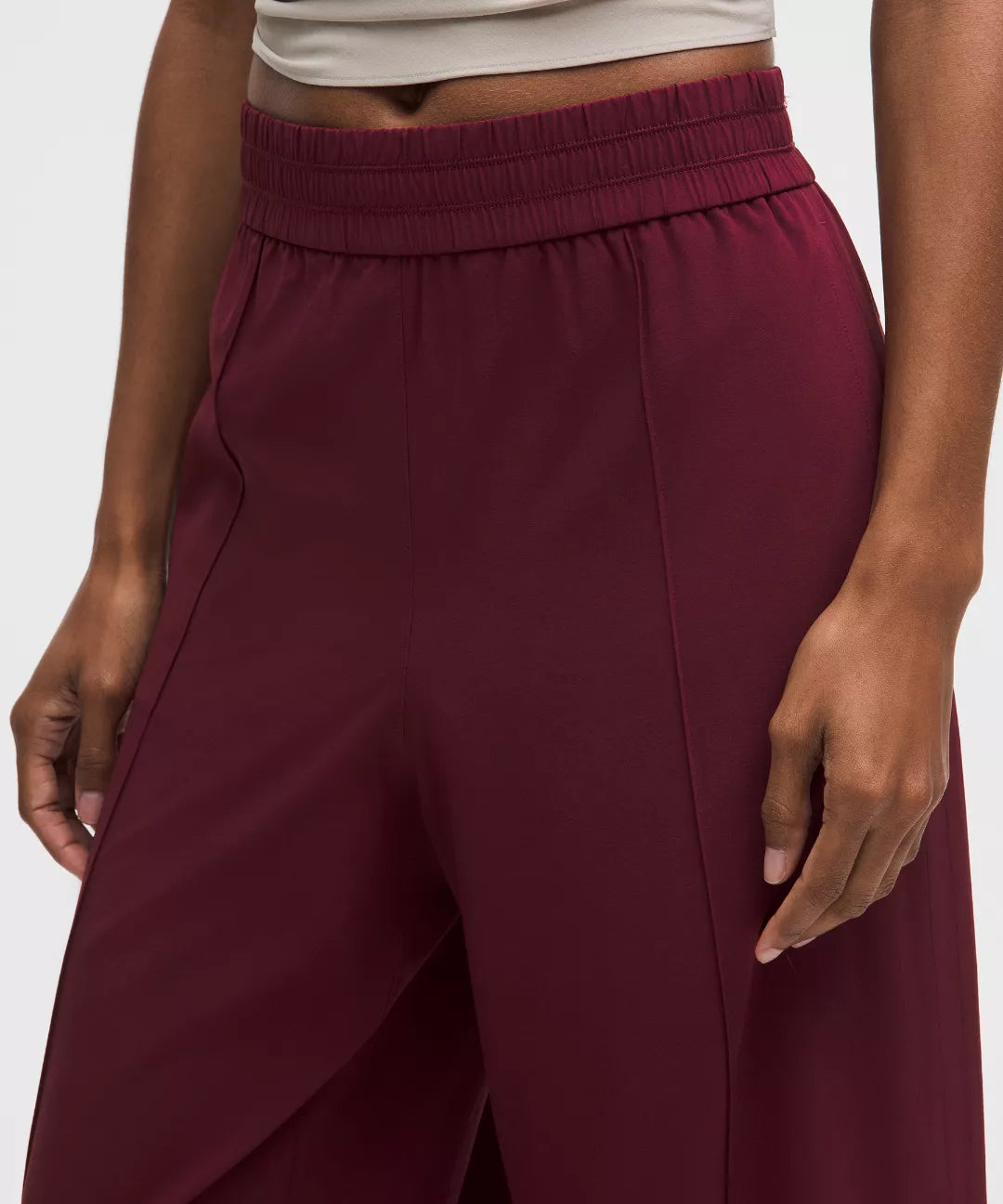 Maroon wide-leg pants worn by a person on a white background