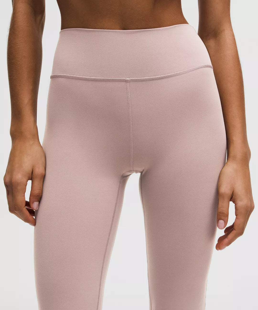 Pink leggings worn by a person on a white background