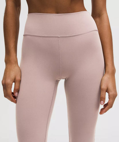 Pink leggings worn by a person on a white background