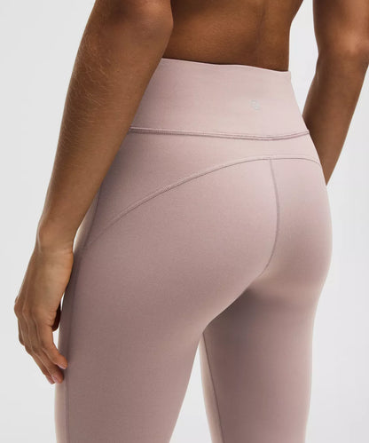 Beige leggings worn by a person on a light gray background