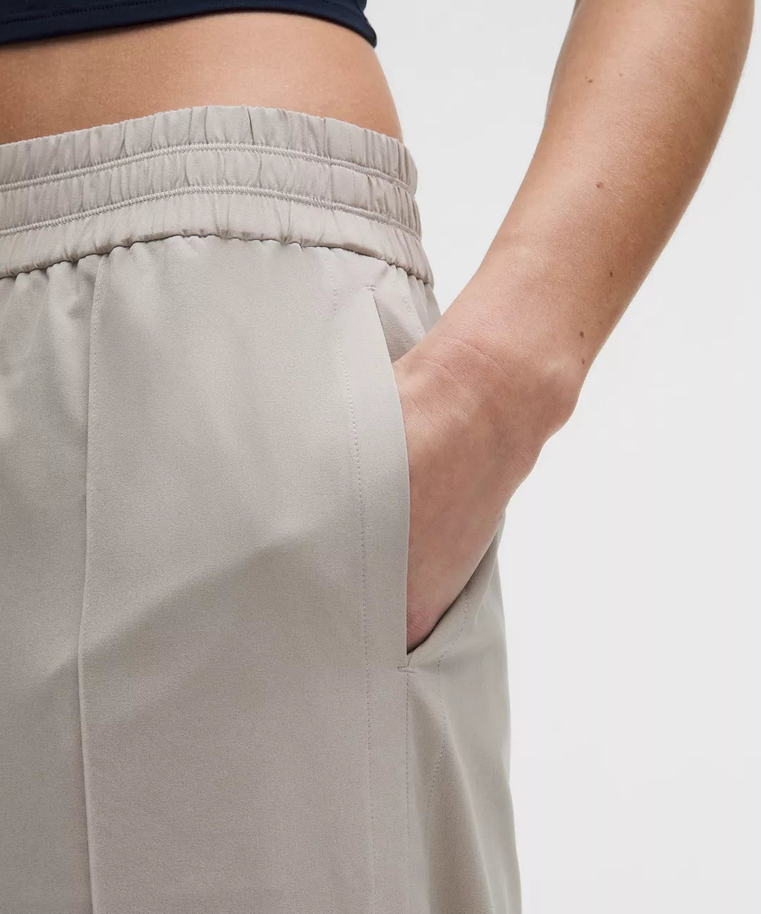 Close-up of beige pants with a plain background