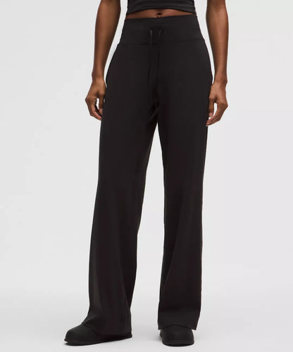 Black pants worn by a person on a white background