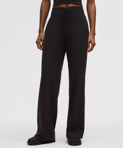 Black pants worn by a person on a white background