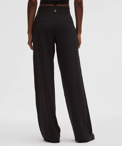 Black wide-leg pants worn by a person on a white background