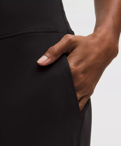 Hand inserting into a black pocket on a plain background