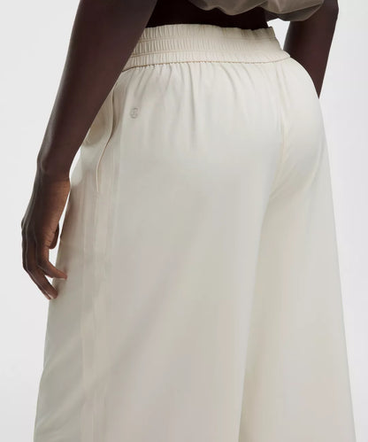 White pants worn by a person on a white background