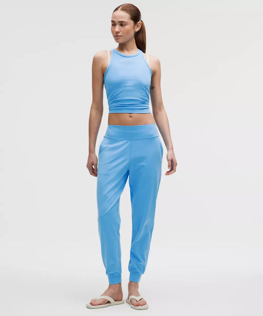 Woman wearing a blue athletic outfit on a white background