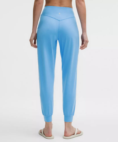 Light blue jogger pants worn by a person on a white background