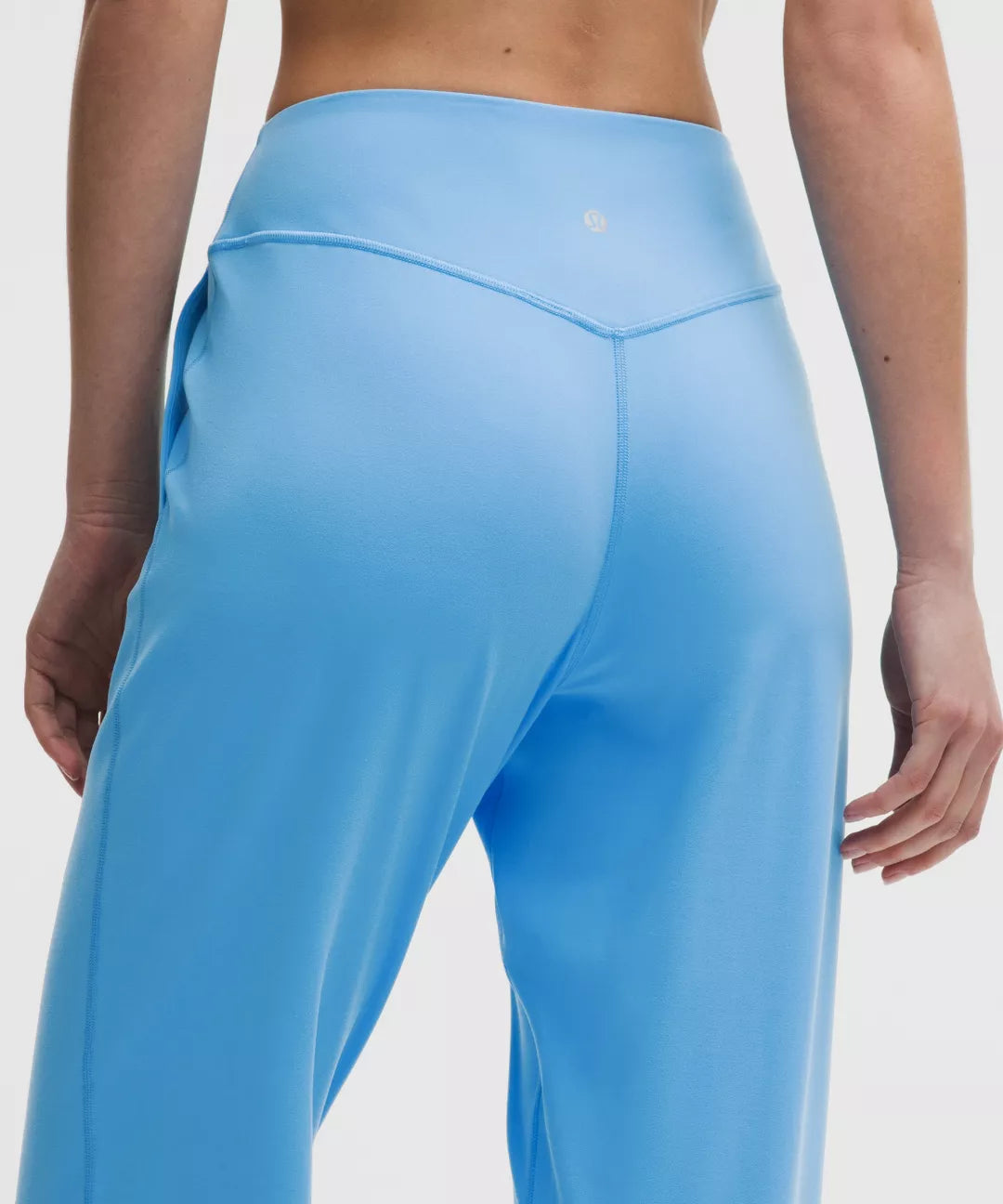 Blue leggings worn by a person on a white background