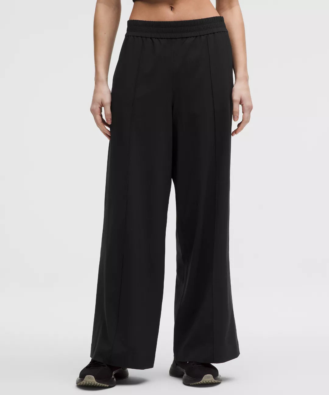 Black wide-leg pants worn by a person on a white background