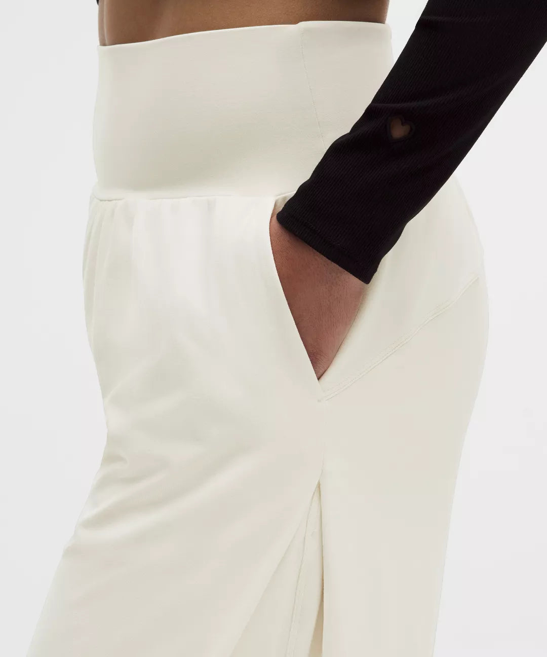 White skirt with a black sleeve and cut-out design on a white background