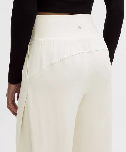 White pants worn by a person with a black top on a white background