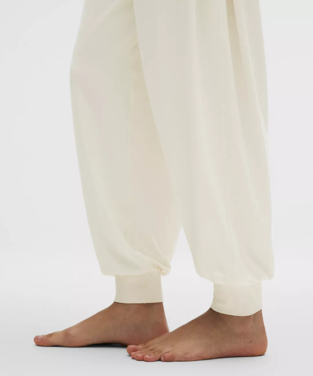 White pants worn by a person on a white background