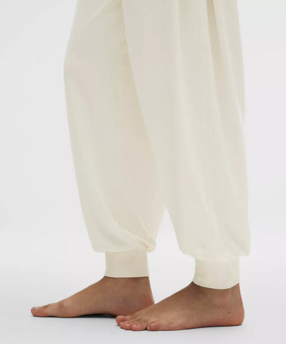 White pants worn by a person on a white background