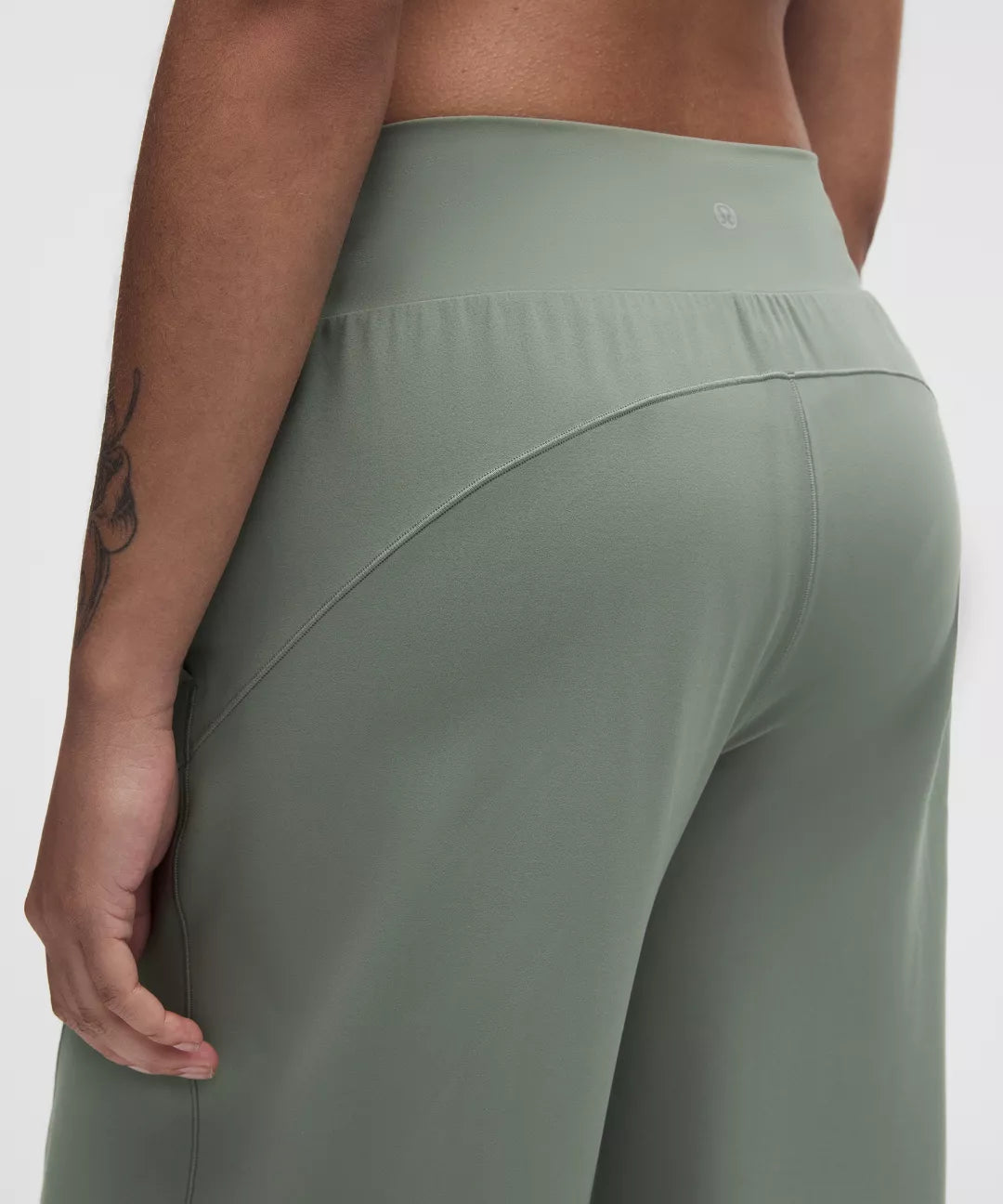 Green leggings worn by a person on a white background