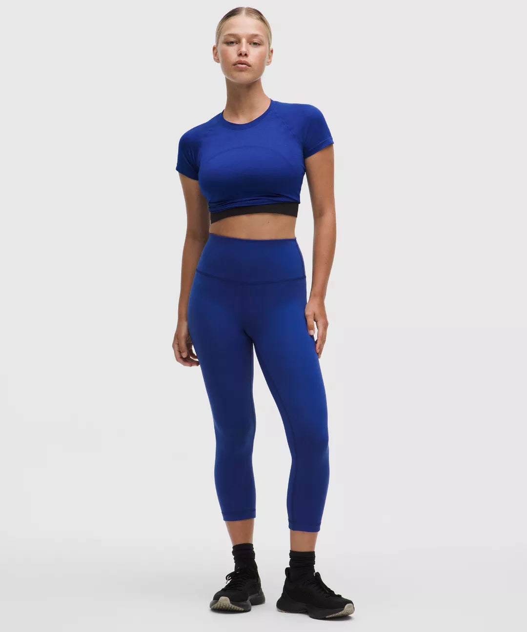 Person wearing a blue athletic outfit on a white background