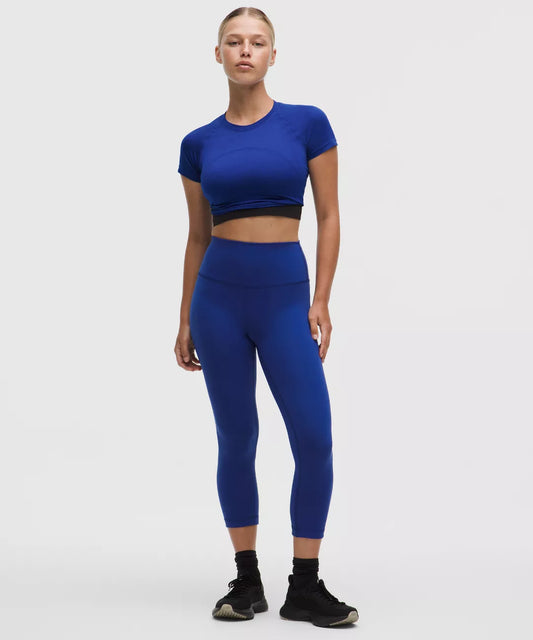 Person wearing a blue athletic outfit on a white background