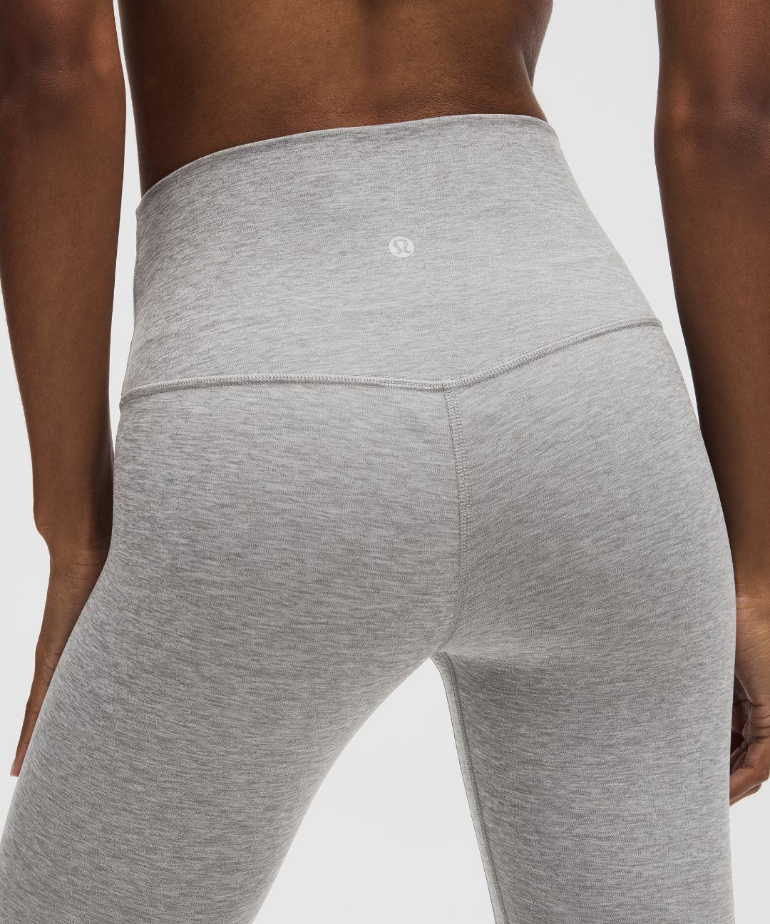 Gray leggings worn by a person on a light gray background