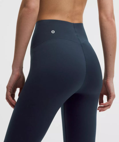 Navy blue leggings with a brand logo on a white background